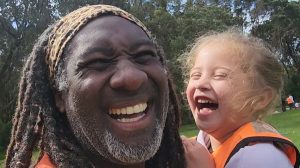 Picture of four year old at Pride Lands laughing with Moses