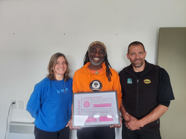 Moses presents a certificate to Help 100 Sponsors Crossroads Accounting