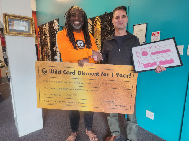 Moses presents a certificate to Help 100 Sponsors Exhibit A