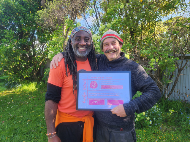 Moses presents a certificate to Help 100 Sponsor Sam Broad