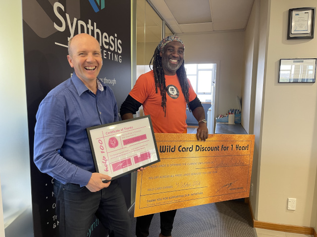 Moses Presenting a certificate to Help 100 Sponsors Synthesis Marketing