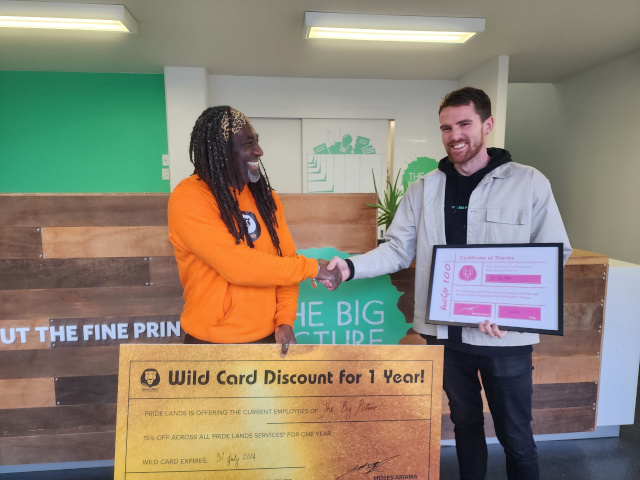 Moses presents a certificate to Help 100 Sponsors The Big Picture